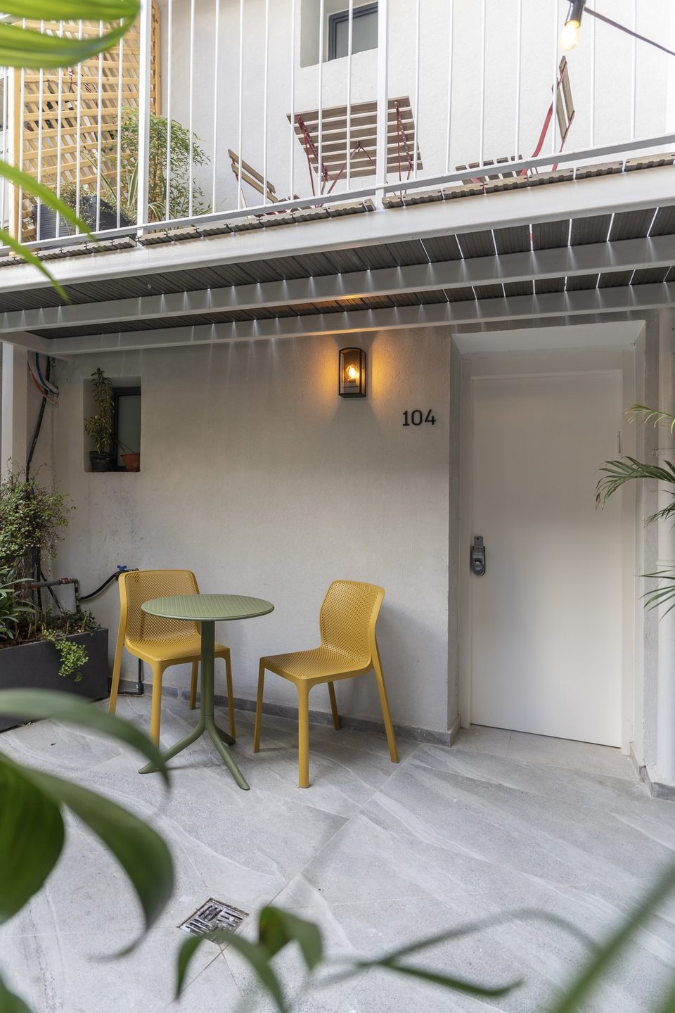 A seating corner in the courtyard by the entrance to room 104