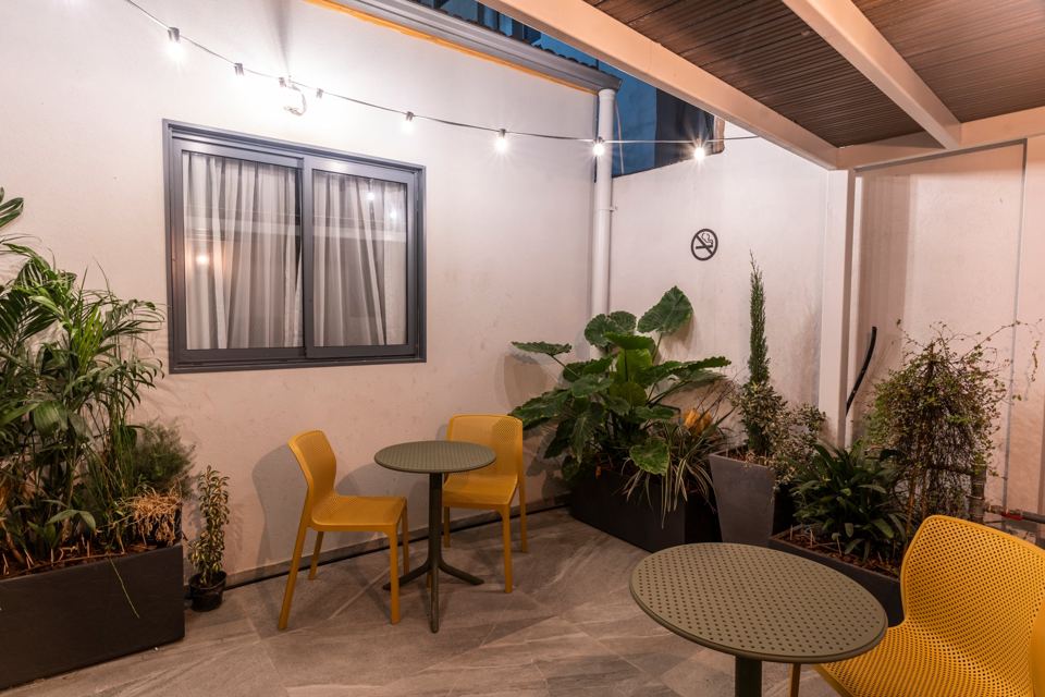Courtyard garden lit by string lights in the evening