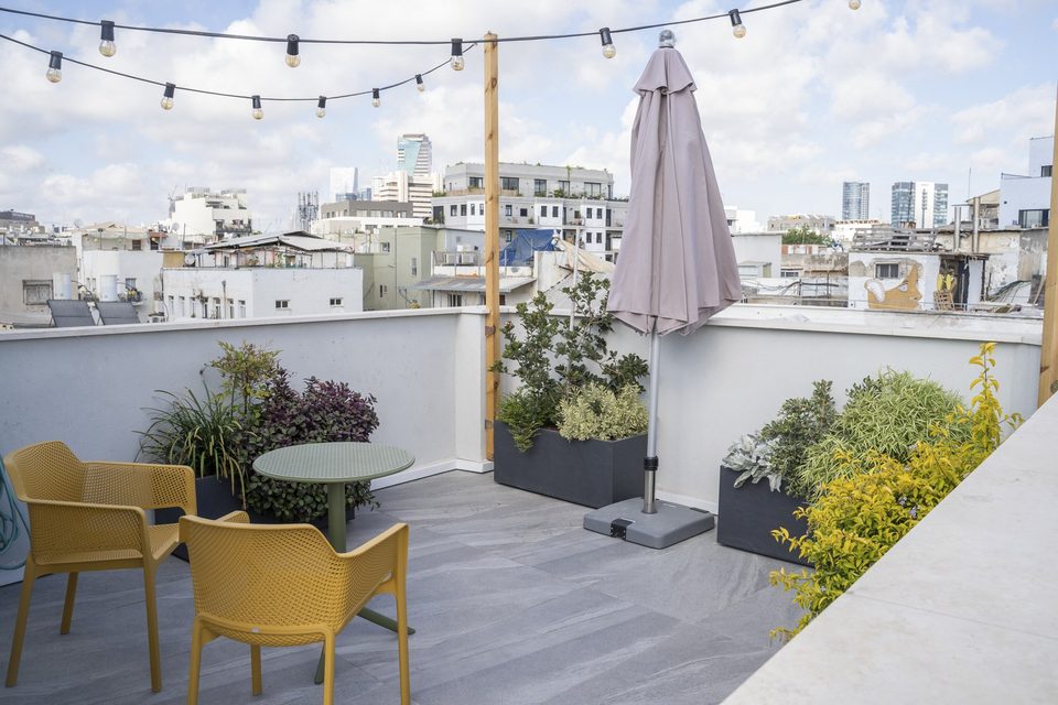 Table et fauteuils sur le toit avec vue sur la ville