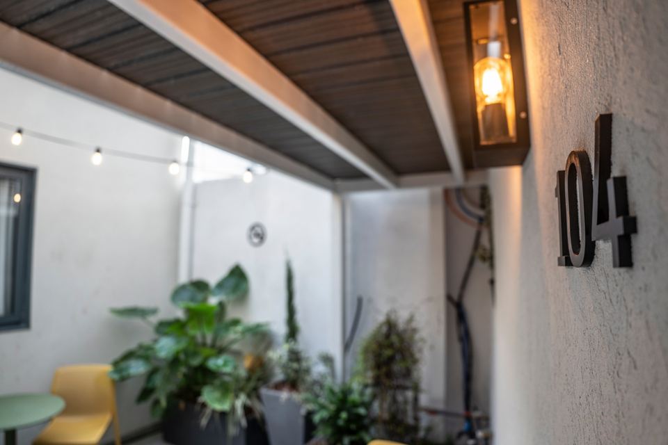 Lantern-style wall light beside the number 104