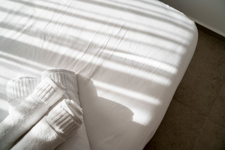 Sunlight across white bed linen